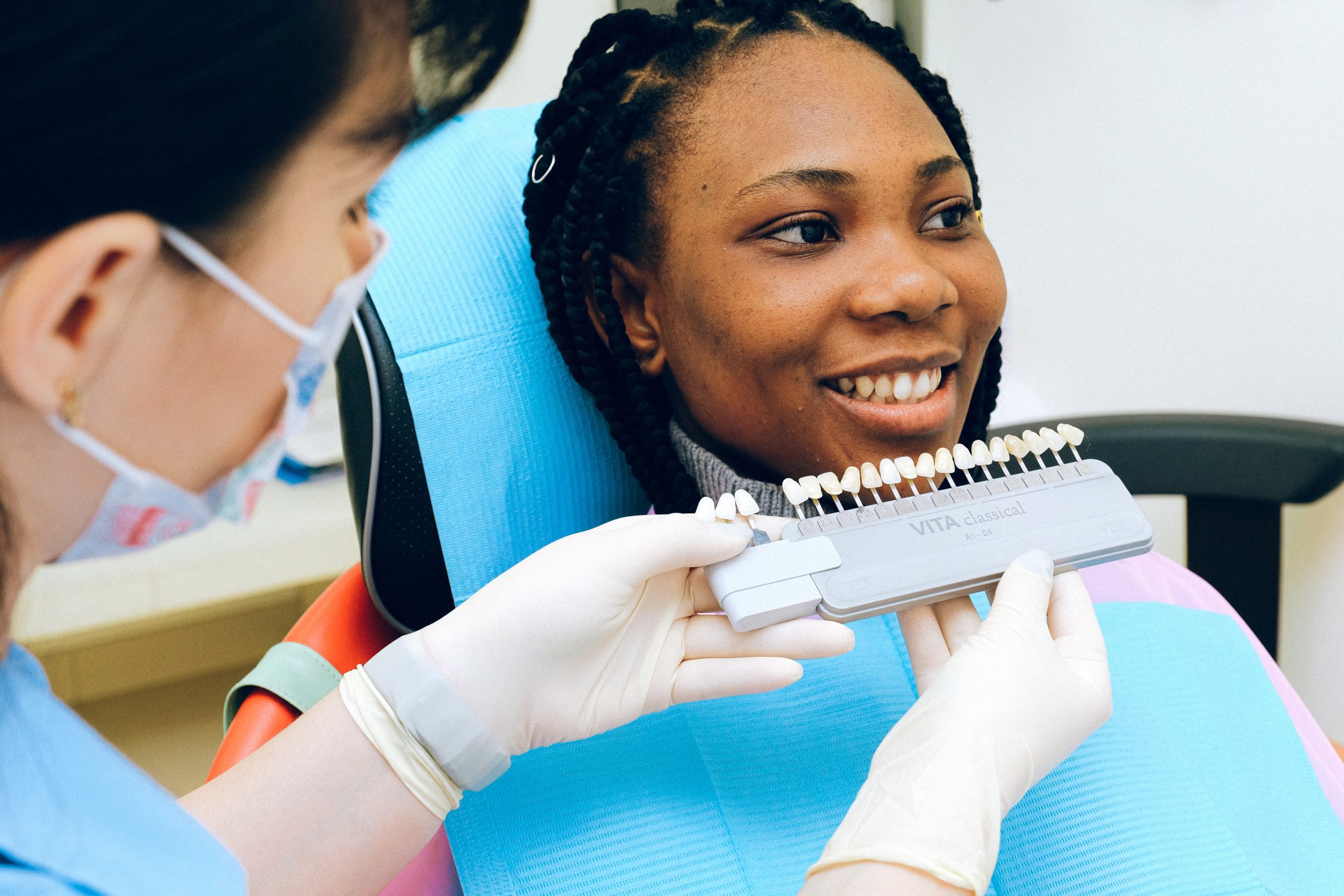 A female patient and dentist examining dental implants