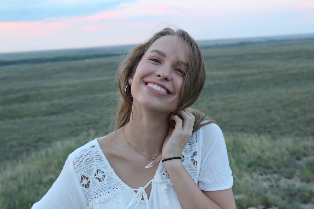 Young woman smiling in a field